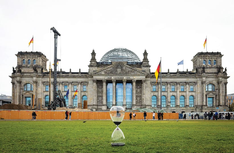  AN HOURGLASS stationed in front of Germany’s Reichstag as part of a global campaign by the Roman family meant to raise awareness of the situation of Israeli hostages in Gaza.  (photo credit: Roman family)