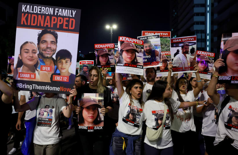  People carry placards during a protest calling for the immediate release of hostages held in Gaza who were seized from southern Israel on October 7 by Palestinian Islamist group Hamas gunmen during a deadly attack, at a square in Tel Aviv, Israel, November 11, 2023. (photo credit: REUTERS/AMMAR AWAD)