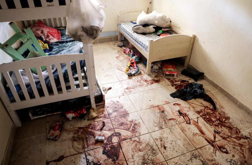  Children's toys and personal items lie on the bloodstained floor of a child's bedroom, following a deadly infiltration by Hamas terrorists from the Gaza Strip, in Kibbutz Beeri in southern Israel October 17, 2023. (photo credit: RONEN ZVULUN/REUTERS)