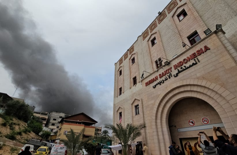  Smoke rises following an Israeli strike near the Indonesian Hospital that ran out of fuel and electricity, in the northern Gaza Strip, November 12, 2023. (photo credit: REUTERS/Anas al-Shareef)