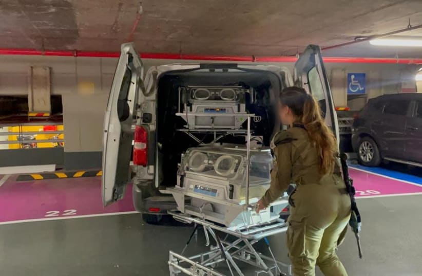  An IDF soldier loads incubators into a van to be delivered to Al-Shifa Hospital in Gaza. November 14, 2023. (photo credit: IDF)