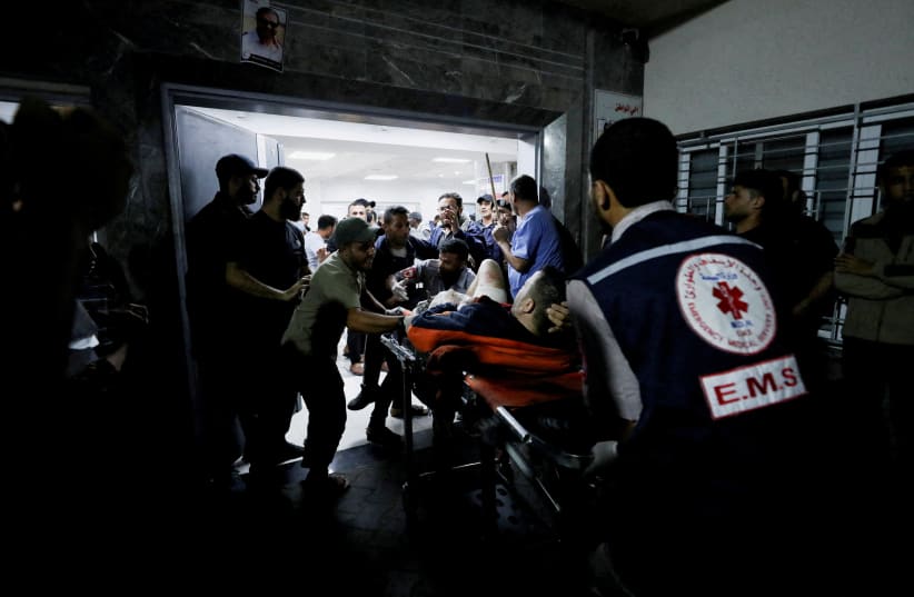  People are assisted at Shifa Hospital after hundreds of Palestinians were killed in a blast at Al-Ahli hospital in Gaza that Israeli and Palestinian officials blamed on each other (photo credit: REUTERS)