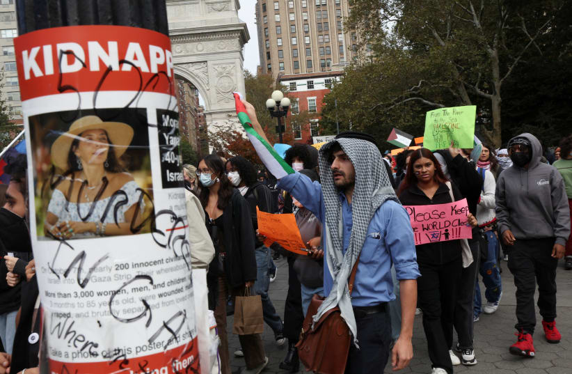  A poster with a picture of a woman and the word "kidnapped," is seen as people attend a demonstration to express solidarity with Palestinians in Gaza as part of a student walkout by students of New York University, in New York City, US, October 25, 2023. (photo credit: Shannon Stapleton/Reuters)