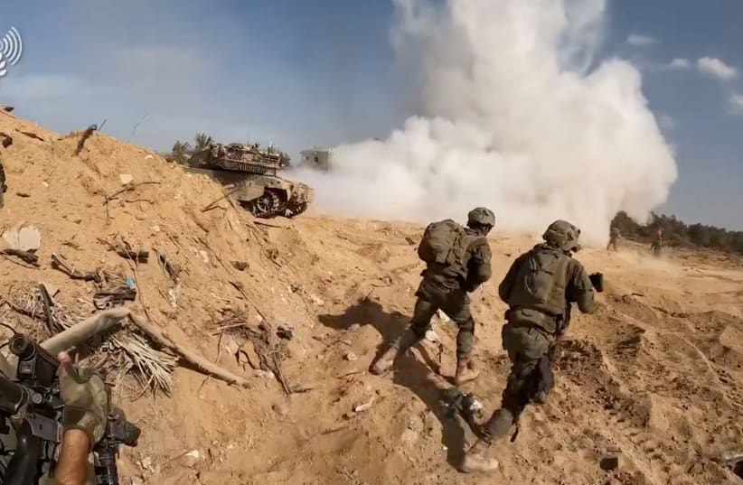  A screengrab taken from a handout video shows what the Israeli army says are its soldiers operating in a location given as the Gaza Strip, released on November 14, 2023. (photo credit: IDF/Handout via REUTERS)