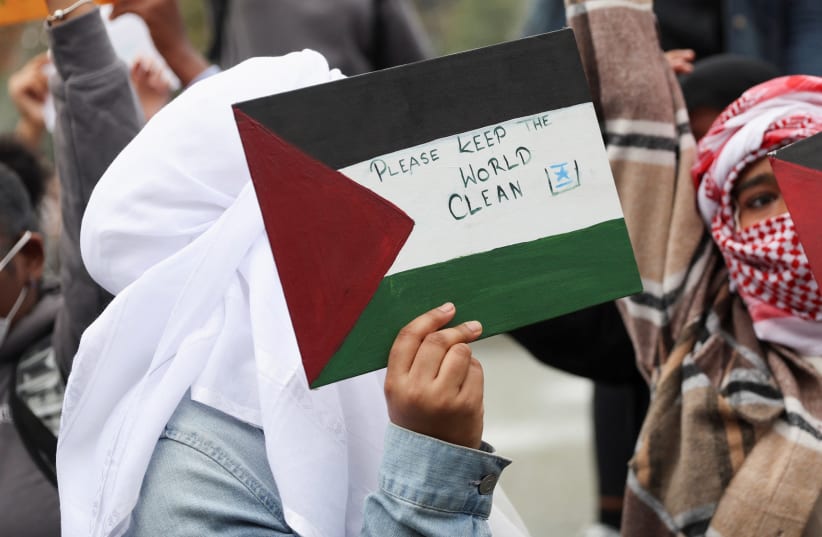  A person holds an antisemitic sign showing a Star of David in the trash at a demonstration against Israel, amid the ongoing conflict between Israel and Hamas, as part of a student walkout by students of New York University, in New York City, U.S., October 25, 2023. (photo credit: REUTERS/SHANNON STAPLETON)