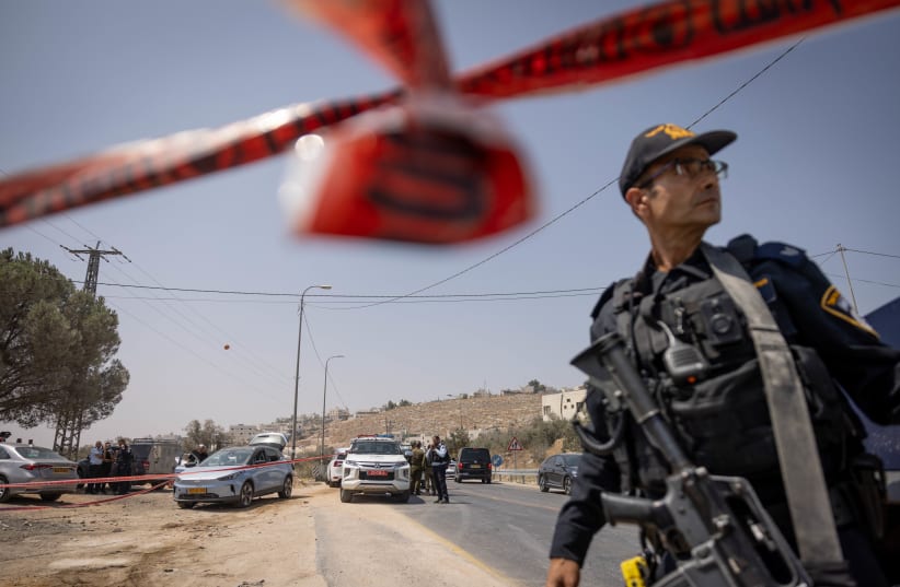 Israeli security forces secure the scene of a shooting attack on Route 60, near Hebron, in the West Bank, August 21, 2023 (photo credit: Chaim Goldberg/Flash90)