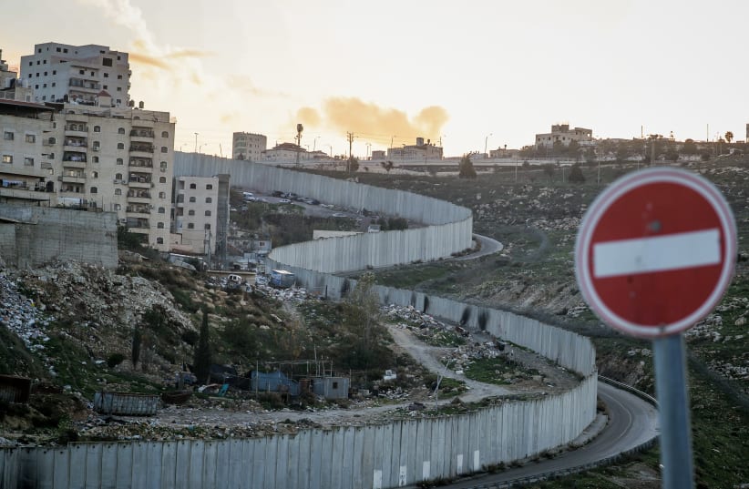 View of a section of Israel's separation wall as it seen from the Jewish neighborhood of Pisgat Ze'ev, in Jerusalem, on January 12, 2023.  (photo credit: JAMAL AWAD/FLASH90)
