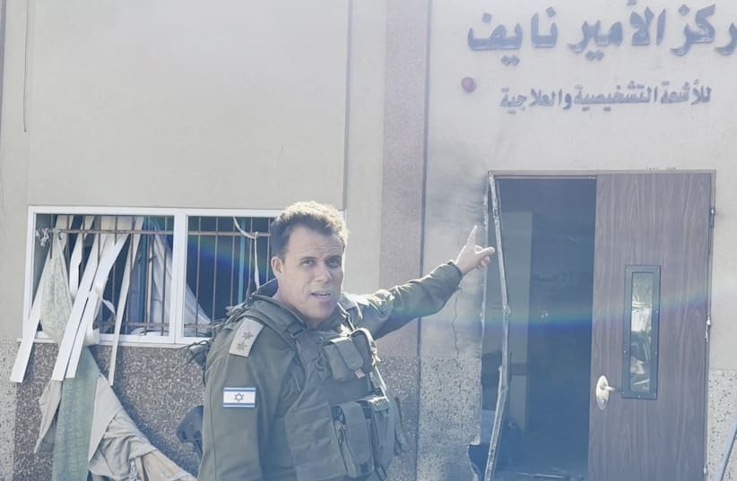  An Israeli officer points at hospital signage at the Al Shifa hospital complex, amid their ground operation against Palestinian Islamist group Hamas, in Gaza City, November 15, 2023 (photo credit: IDF SPOKESPERSON'S UNIT)