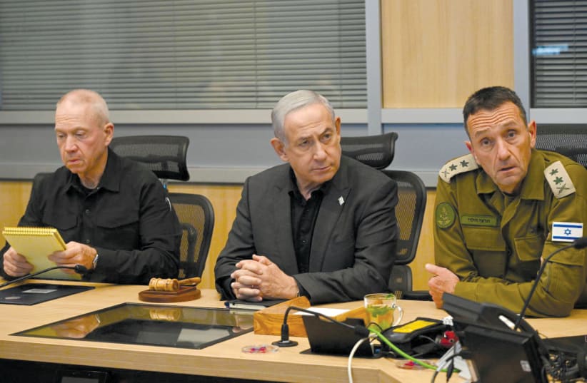 Prime Minister Benjamin Netanyahu, flanked by Defense Minister Yoav Gallant (left) and IDF Chief of Staff Lt.-Gen. Herzi Halevi, holds a security assessment in Tel Aviv. (photo credit: HAIM ZACH/GPO)