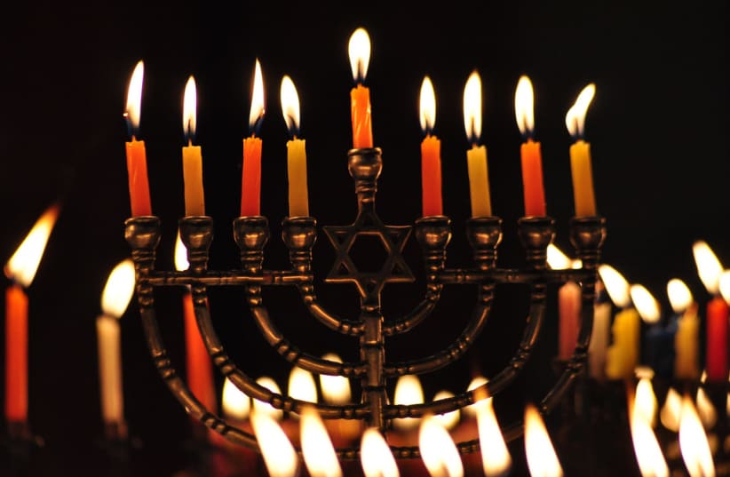  A Hanukkah menorah with lit candles. (photo credit: FLICKR)