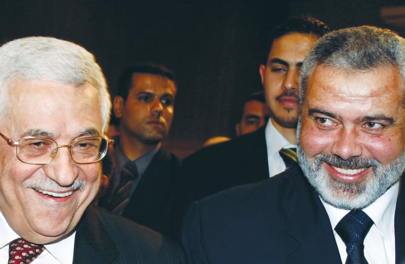  PA head Mahmoud Abbas of Fatah and then-prime minister Ismail Haniyeh of Hamas in the Palestinian Legislative Council, in March 2007, just before the Hamas coup in the Gaza Strip in June: Fatah and Hamas collaborated during the Second Intifada. (photo credit: SUHAIB SALEM/REUTERS)