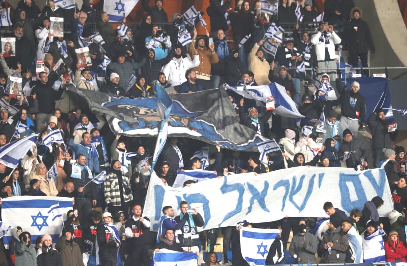  ISRAEL FANS display flags and signs during the blue-and-white’s Euro 2024 qualifier against Romania on Saturday night at Pancho Arena in Felcsút, Hungary. (photo credit: Bernadett Szabo/Reuters)