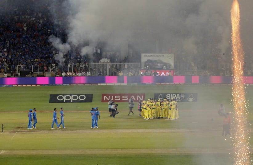 Cricket - ICC Cricket World Cup 2023 - Final - India v Australia - Narendra Modi Stadium, Ahmedabad, India - November 19, 2023 Australia players celebrate after winning the ICC Cricket World Cup as India players reacts (photo credit: Adnan Abidi/Reuters)