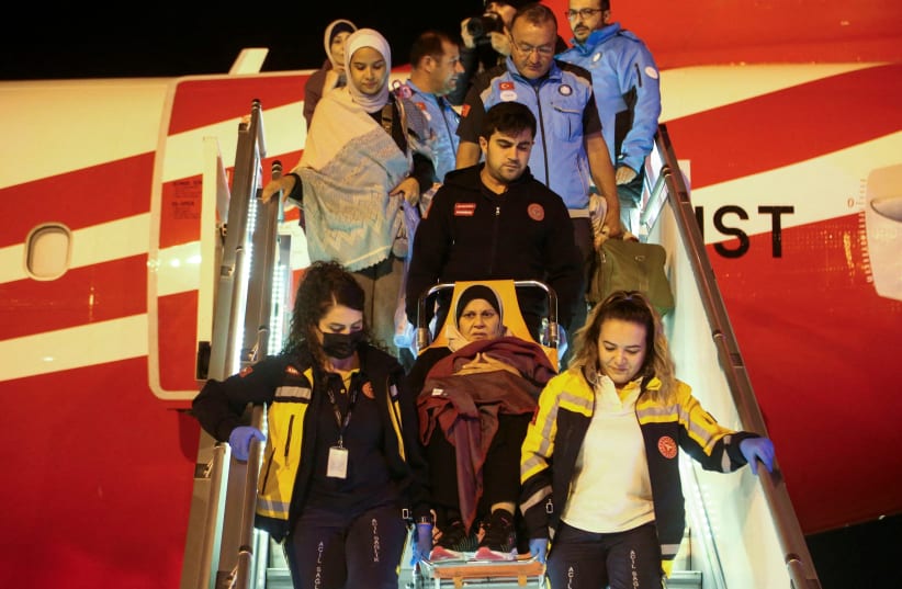  Medical staff carry a Palestinian cancer patient who was evacuated from Gaza to Egypt and brought to Turkey by plane, at Esenboga Airport in Ankara, Turkey November 16, 2023. (photo credit: REUTERS)