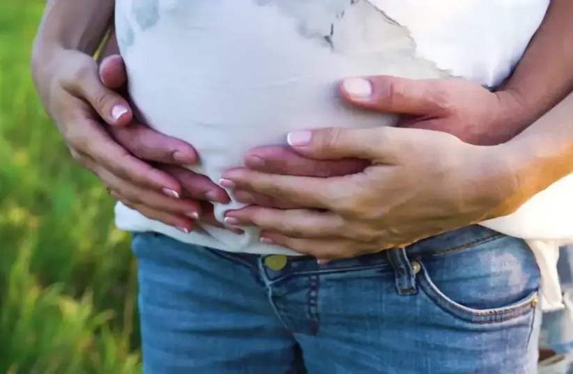  A couple with hands on the woman's belly (photo credit: SHUTTERSTOCK)