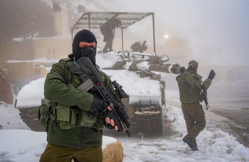  Israeli soldiers patrol in the snow in Mount Hermon, near the Israeli border with Lebanon, northern Israel, November 20, 2023 (photo credit: AYAL MARGOLIN/FLASH90)