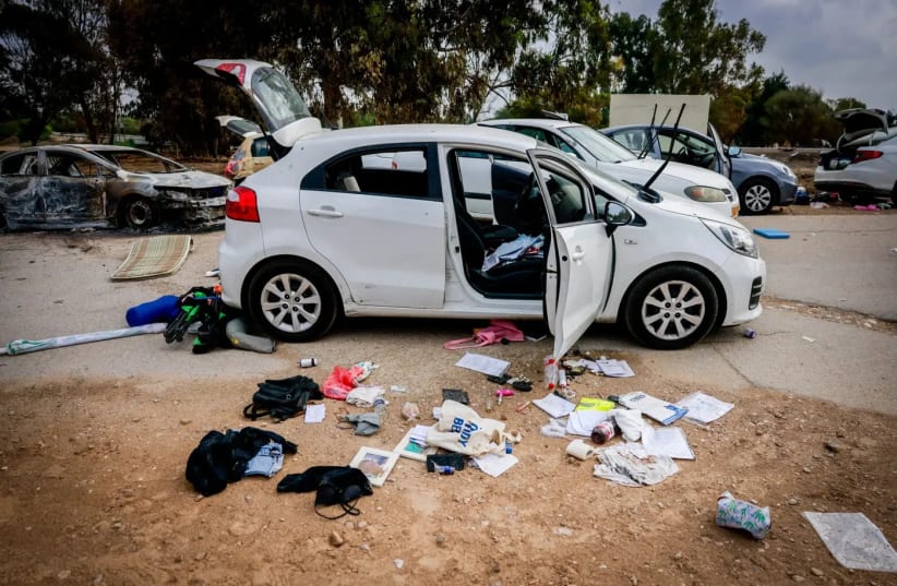 Personal belongings near cars abandoned following the party in Kibbutz Re'im (photo credit: Chaim Goldberg/Flash90)
