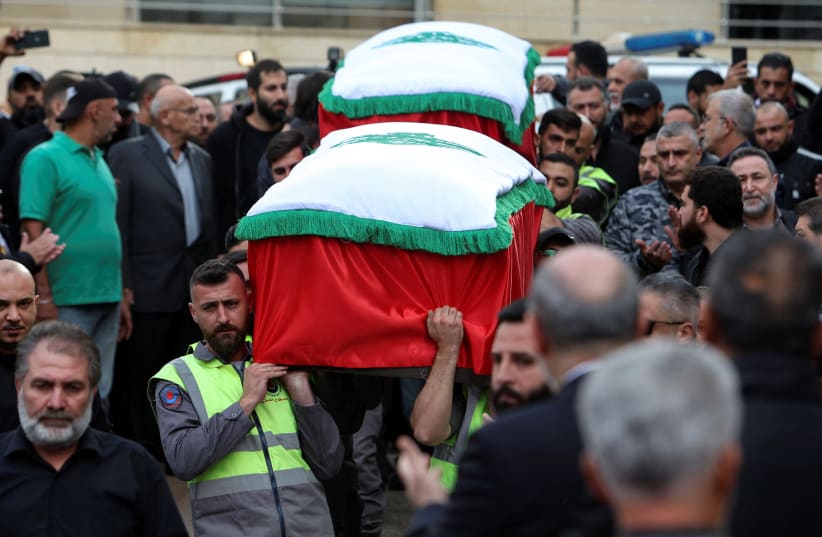  Civil defence members carry the coffins of the two journalists said to be killed by an Israeli strike on Tuesday in southern Lebanon, as mourners gather outside the channel's building to offer prayers ahead of their funeral, in Beirut, Lebanon November 22, 2023. (photo credit: REUTERS/AZIZ TAHER)