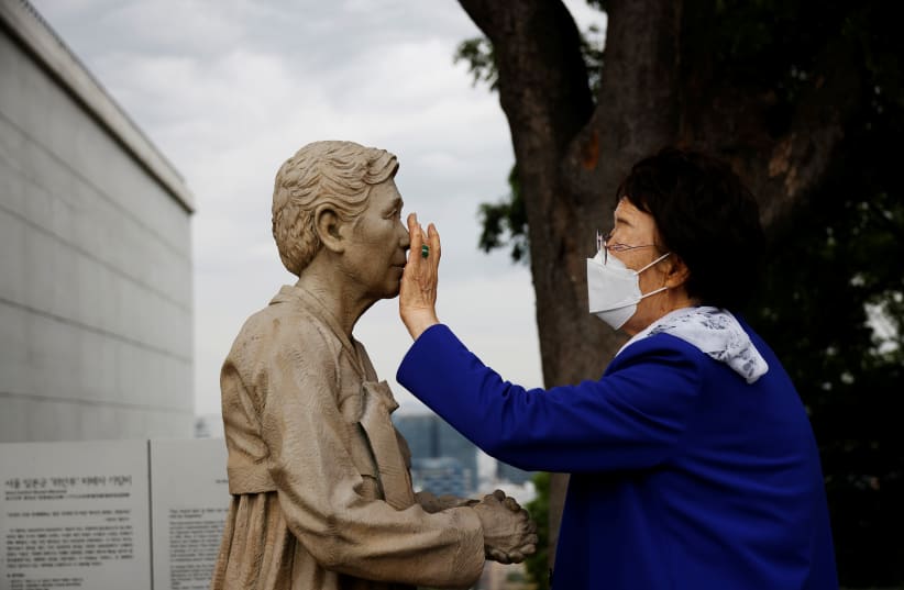  Former South Korean "comfort woman" Lee Yong-soo looks at a statue symbolising "comfort women" at the Seoul Comfort Women Memorial in Seoul, South Korea, June 29, 2021 (photo credit: REUTERS/KIM HONG-JI)