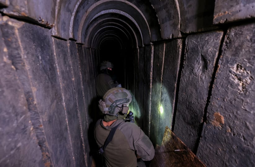  An Israeli soldier walks through a tunnel underneath Al Shifa Hospital in Gaza City, amid the ongoing ground operation of the Israeli army against Palestinian Islamist group Hamas, in the northern Gaza Strip, November 22, 2023. REUTERS/Ronen Zvulun EDITOR'S (photo credit: REUTERS/Ronen Zvulun)