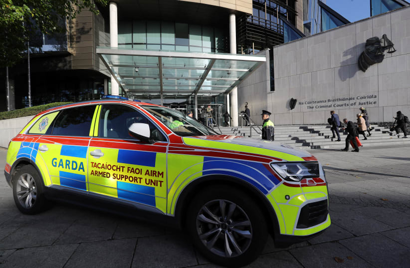 View of a vehicle as armed police officers stand outside the Special Criminal Court, where Gerry "The Monk" Hutch is appearing, charged with the murder of David Byrne at the Regency Hotel in Dublin in 2016, in Dublin, Ireland October 10, 2022. (photo credit: REUTERS/LORRAINE O'SULLIVAN)