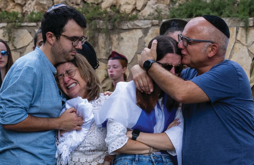  HUMANIZE IT: The mother, sister, and immediate family of Valentin (Eli) Ghnassia, 23, killed in Kibbutz Be’eri, at his October 12 funeral.  (photo credit: Alexi J. Rosenfeld/Getty Images)