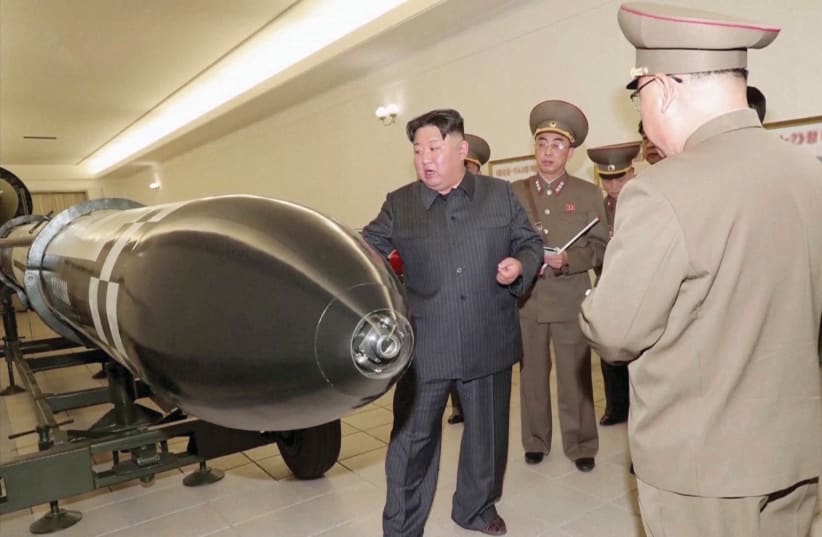  NORTH KOREAN leader Kim Jong Un inspecting nuclear warheads at an undisclosed location.  (photo credit: KRT/via Reuters TV/Handout via Reuters)