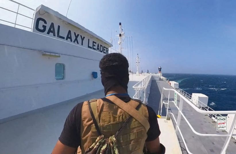  A HOUTHI fighter guards the deck of the ‘Galaxy Leader’ cargo ship in the Red Sea (photo credit: Houthi Military Media/Reuters)