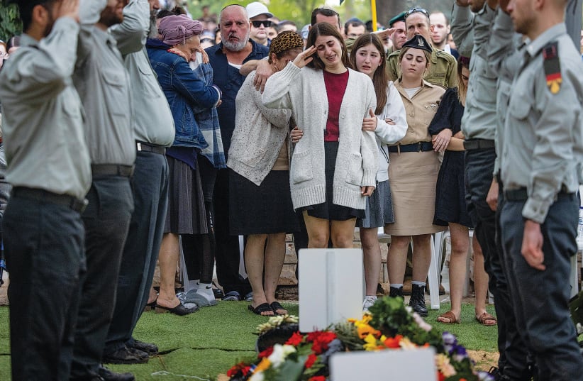  NAAMA, THE FIANCÉE of Cpt. Kfir Yitzchak Franco (inset), surrounded by their families and friends, salutes him at his funeral at Jerusalem’s Mount Herzl military cemetery on November 16 (photo credit: Chaim Goldberg/Flash90)