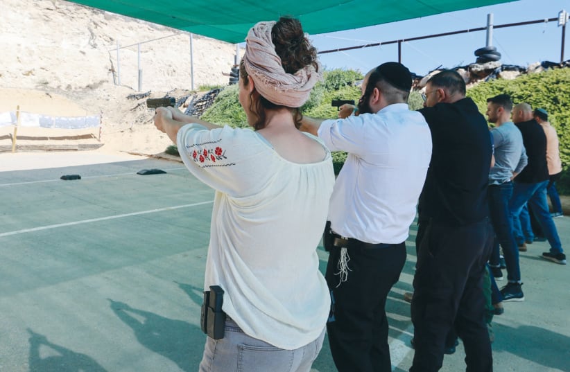  CALIBER 3 shooting range in Gush Etzion, earlier this month: Over the past month, more than 200,000 Israelis have filed applications for gun licenses.  (photo credit: MARC ISRAEL SELLEM/THE JERUSALEM POST)