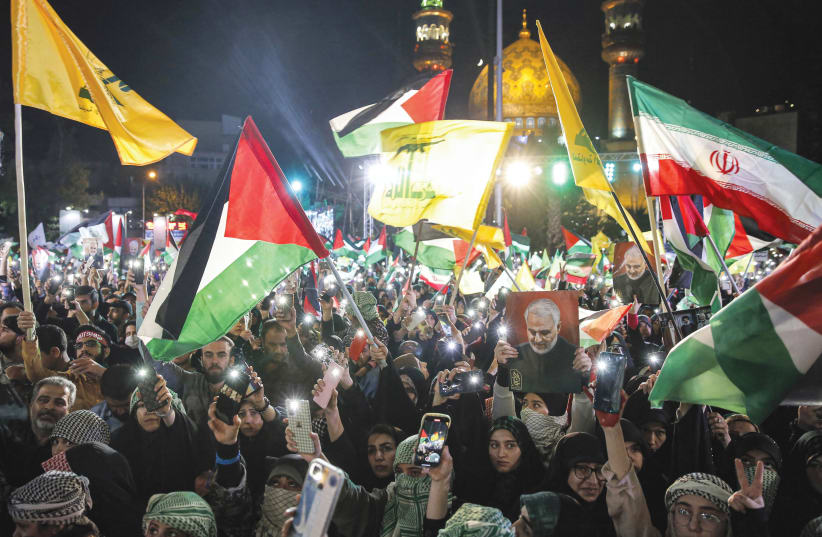 WAVING IRANIAN, Palestinian, and Hezbollah flags at an anti-Israel protest in Tehran, Oct. 20. (photo credit: AFP VIA GETTY IMAGES)