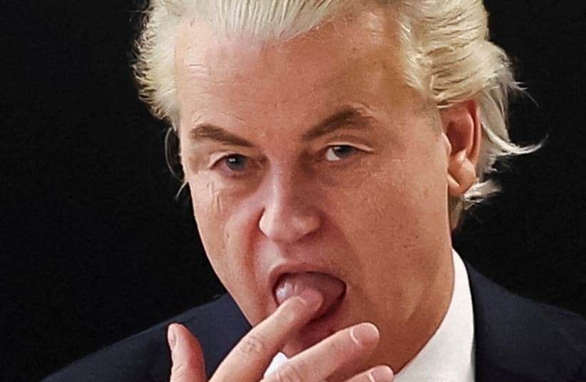Dutch far-right politician and leader of the PVV party, Geert Wilders licks his finger as he meets with members of his party at the Dutch Parliament, after the Dutch parliamentary elections, in The Hague, Netherlands November 23, 2023 (photo credit: YVES HERMAN/REUTERS)