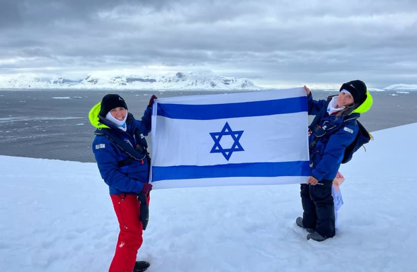  Marine biologists Prof. Tali Mass (left) and Dr. Tal Luzzatto Knaan raise the Israeli flag in Antarctica, 2023. (photo credit: Courtesy)