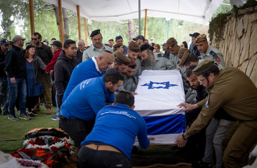  Family and friends of Israeli soldier Captain Liron Snir mourn at his funeral at the Mount Herzl Military Cemetery in Jerusalem on November 22, 2023, he was killed during a ground operation in the Gaza Strip (photo credit: Chaim Goldberg/Flash90)