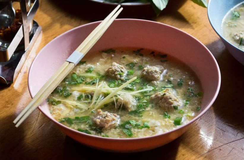 A meal in a bowl. Thai Khao Tom soup based on rice with chicken meatballs (photo credit: DROR EINAV)