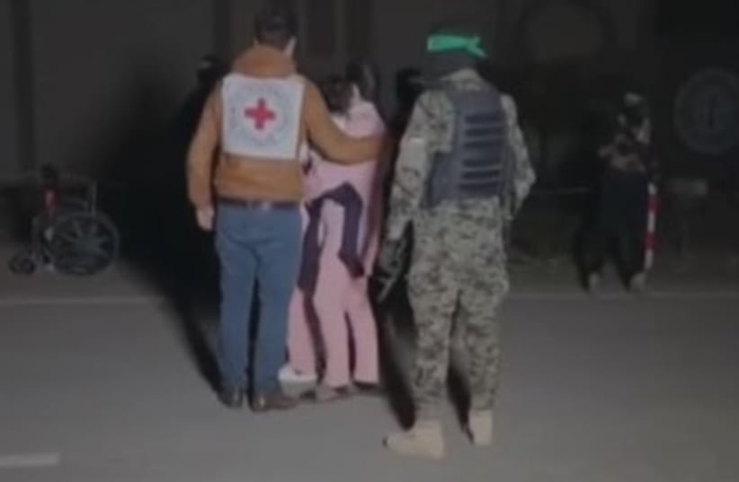 Hamas terrorists hand over Israeli hostages to Red Cross officials, November 27, 2023 (photo credit: screenshot)