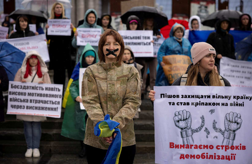  Antonina Danylevych, whose husband Oleksandr has been fighting against Russia’s invasion on Ukraine since March 2022, attends a protest in Kyiv calling for an end to open-ended military service, November 12, 2023 (photo credit: REUTERS/THOMAS PETER)