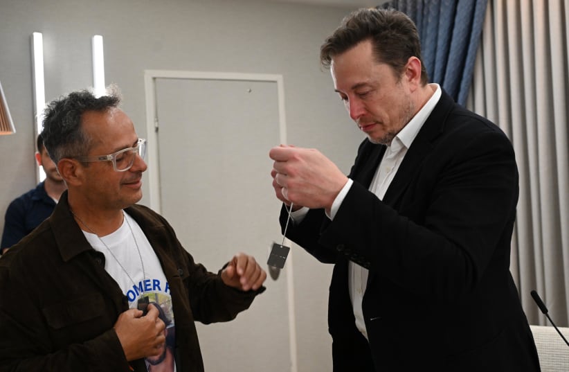  Malki Shem Tov presents Elon Musk with a military dog tag at the President's Residence, November 27, 2023 (photo credit: HAIM ZACH/GPO)