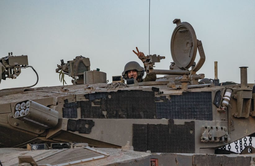  An IDF soldier in a tank near the Israel-Gaza border, this week: The only way to also achieve securing our hostages is by first and foremost defeating Hamas, the writer argues. (photo credit: YONATAN SINDEL/FLASH90)