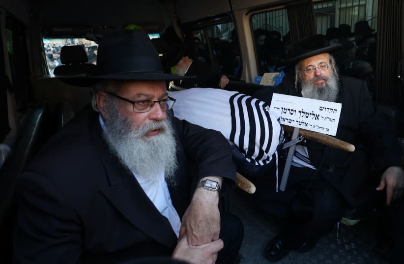  People mourn rabbinical judge, Elimelech Wasserman, who was killed in a shooting attack when Hamas gunmen opened fire at a bus stop at the entrance to Jerusalem, in a hearse, ahead of the funeral in Jerusalem November 30, 2023 (photo credit: REUTERS/Ronen Zvulun)