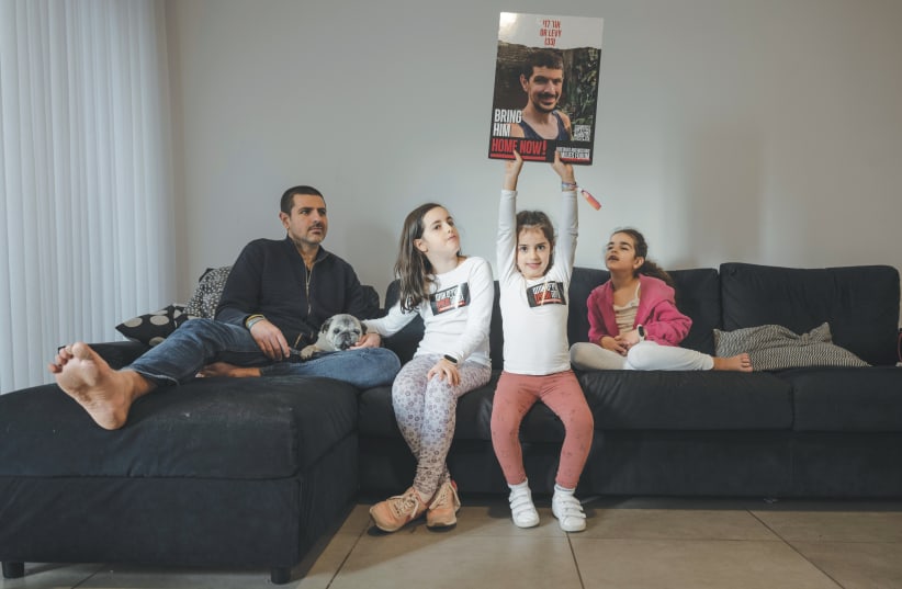  MICHAEL LEVY at home with his three daughters: ‘Now my mission is to bring him back. If I have to turn the world upside down to do so – so be it.’ (photo credit: CHEN SCHIMMEL)