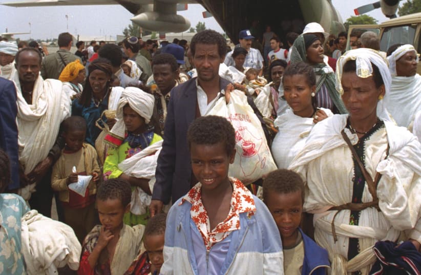  NEW OLIM rescued from Ethiopia step out of an IAF Hercules at a base in Israel, during Operation Solomon, May 1991. (photo credit: Wikimedia Commons)