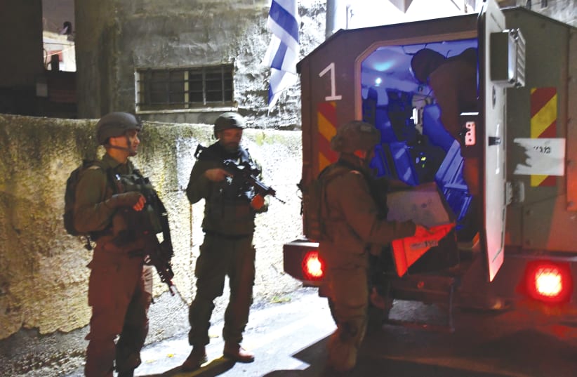  IDF SOLDIERS prepare the home of a terrorist for demolition in the early hours of November 28. (photo credit: SETH J. FRANTZMAN)