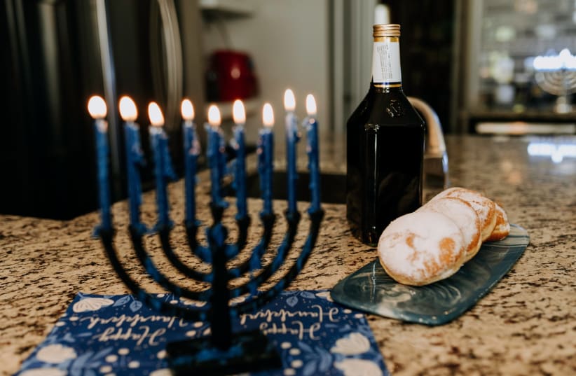  A Hanukkah menorah and sufganiyot. (photo credit: PXHERE)