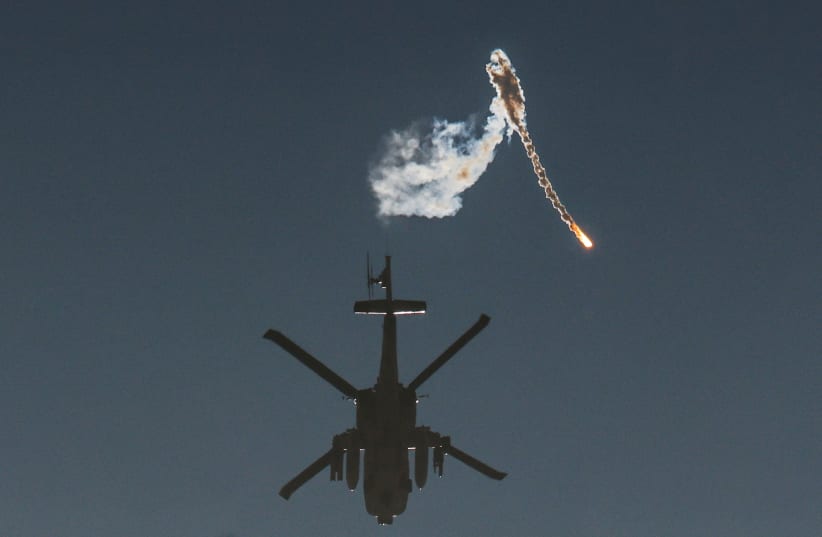  An Israeli military helicopter releases a flare over the Israel-Gaza border, after a temporary truce between Israel and the Palestinian terrorist group Hamas ended, as seen from southern Israel, December 1, 2023. (photo credit: AMIR COHEN/REUTERS)