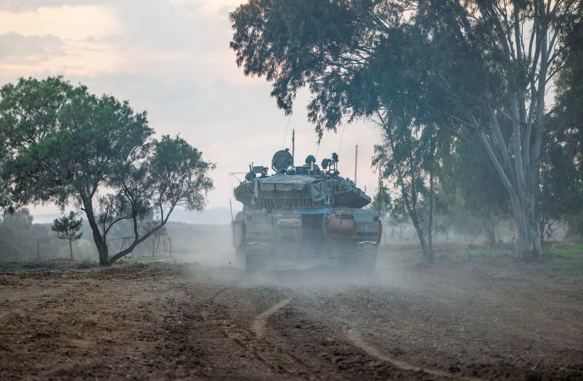  An IDF tank heads through the area near the Gazan border, this past week. (photo credit: YONATAN SINDEL/FLASH90)