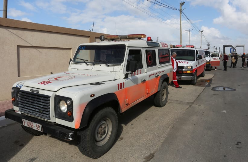 A man walks next to ambulances carrying premature babies, who were evacuated from Al Shifa hospital, before they are transported for treatment in UAE, at Rafah border crossing with Egypt, in Rafah, in the southern Gaza Strip, November 20, 2023 (photo credit: REUTERS/Hatem Khaled)