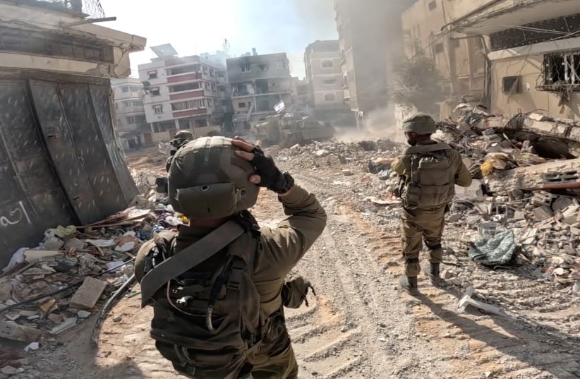   Israeli troopers operate in the Gaza Strip amid the ongoing war between Israel and the Palestinian Islamist neighborhood Hamas, on this disguise grab taken from a handout video launched on December 4, 2023.  (photo credit ranking: REUTERS/IDF HANDOUT)