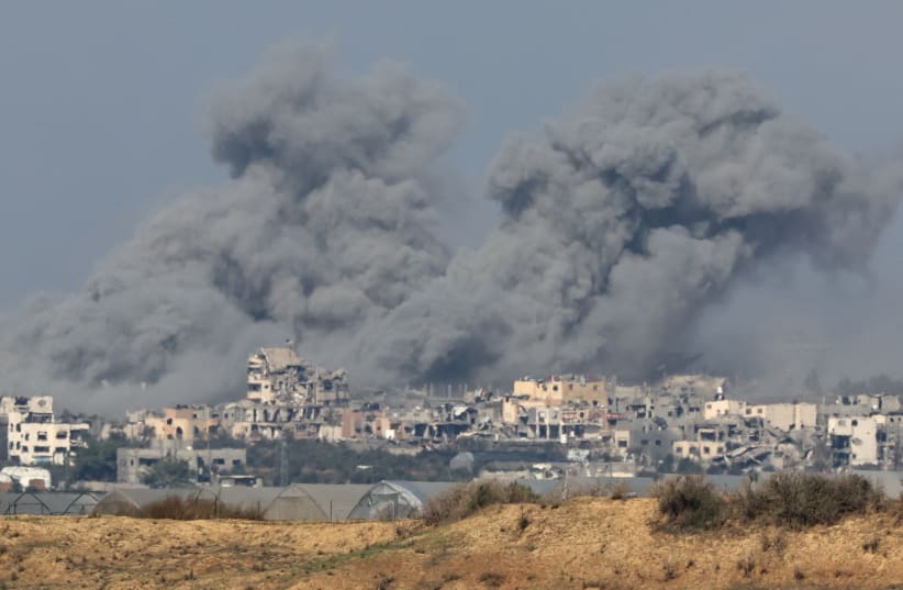  Smoke rises over destroyed buildings in Gaza, amid the ongoing conflict between Israel and the Palestinian Islamist group Hamas, as seen from southern Israel, December 6, 2023. (photo credit: ATHIT PERAWONGMETHA / REUTERS)