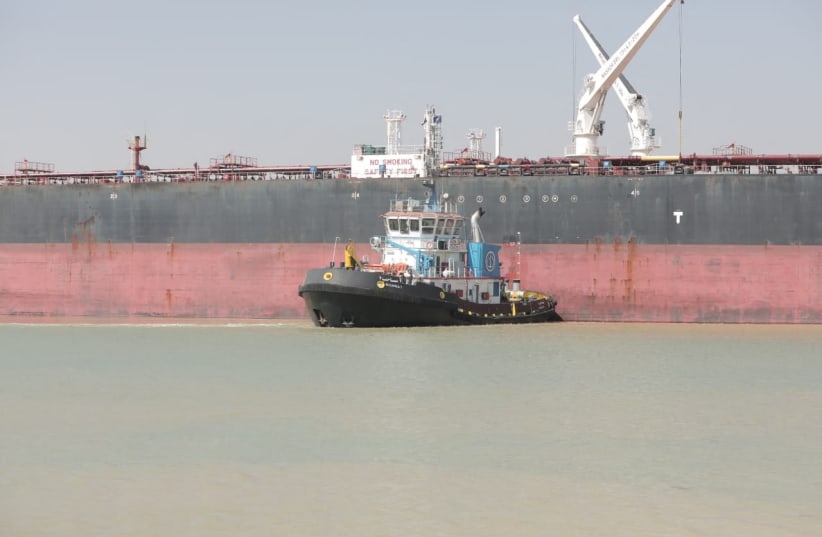  A tugboat works to refloat the Oil Products Tanker BURRI after it collided with LNG Tanker BW Lesmes in the waterway of the Suez Canal, Egypt, August 23, 2023 (photo credit: SUEZ CANAL AUTHORITY/HANDOUT VIA REUTERS)